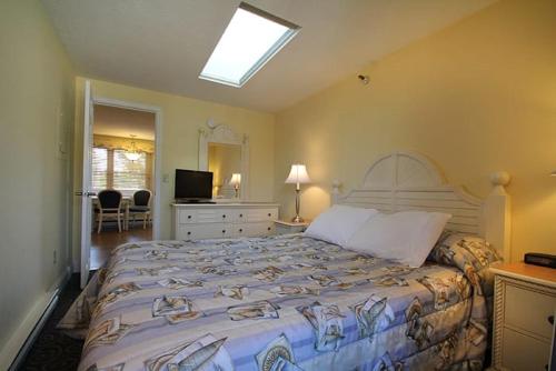 um quarto com uma cama grande e uma clarabóia em Nautical Mile Resort em Wells