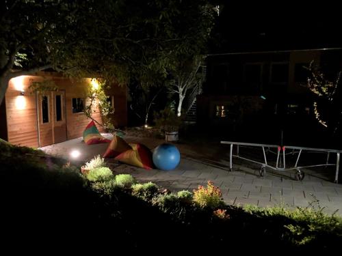 a backyard at night with a ping pong ball and a table at Hello Balaton in Alsóörs