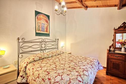 a bedroom with a bed and a dresser in it at Lake Apartment in Villa Massi in Poggio Alla Croce