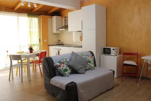 a living room with a couch and a kitchen at Casa Peppino in Letojanni