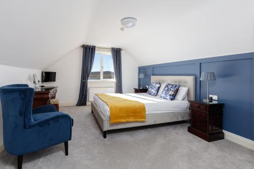 1 dormitorio con 1 cama y 1 silla azul en The Lighthouse en Dingle