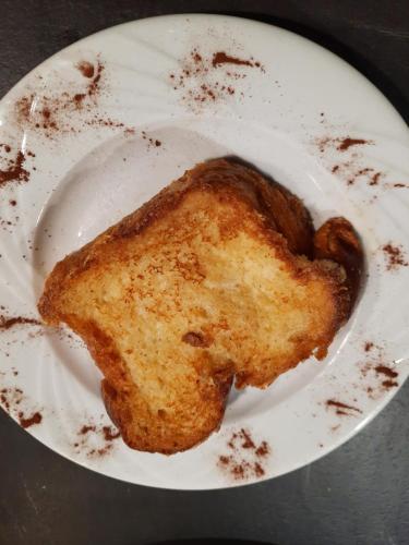 a white plate with a piece of food on it at Au Cœur des Lacs - Chambres d'hôtes in Gérardmer