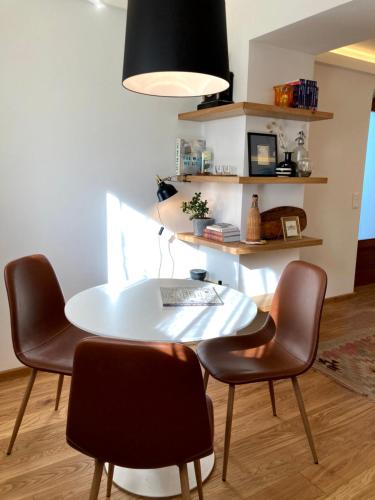 a white table and two chairs in a room at Hello Balaton in Alsóörs