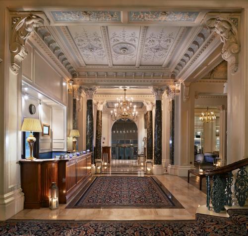 a large lobby with a large room with a ceiling at The Grand Brighton in Brighton & Hove