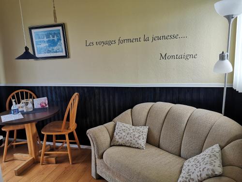 a living room with a couch and a table at Les Cabines du Phare in Rimouski