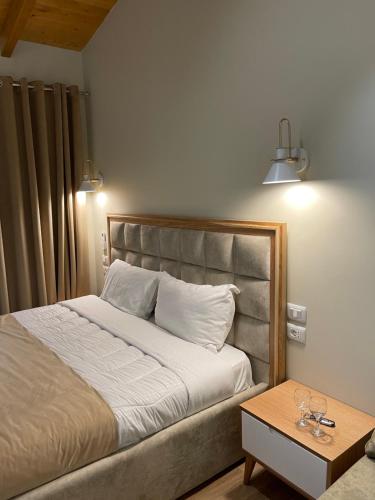 a bedroom with a bed and a table at Arial Penthouse Suites in Vlorë
