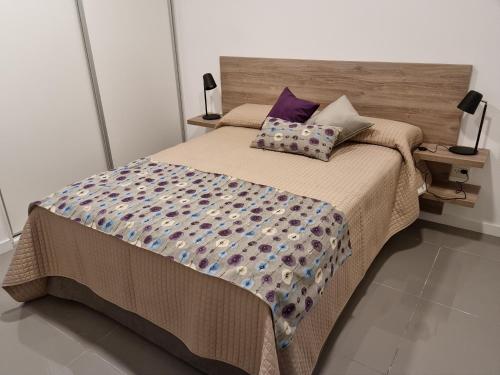 a bed with two pillows on it in a bedroom at Departamento Caleufu in Neuquén