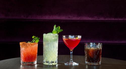 a group of three cocktails sitting on a table at Kissel Uptown Oakland, in the Unbound Collection by Hyatt in Oakland