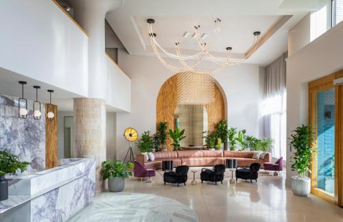 a lobby of a hotel with a couch and chairs at Kissel Uptown Oakland, in the Unbound Collection by Hyatt in Oakland