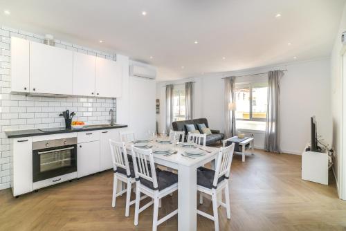 a kitchen and living room with a table and chairs at LXR Bellavista 3Hab. Next to Sea in Fuengirola