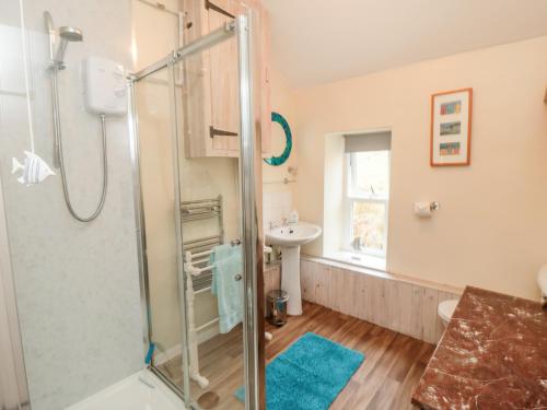 a bathroom with a shower and a sink at Ghyll Cottage in Rosedale Abbey
