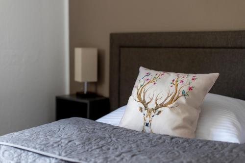a pillow with a tree on it sitting on a bed at Bergische Schweiz in Engelskirchen
