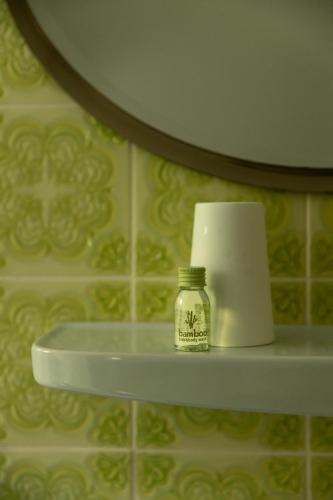 a bathroom shelf with a candle and a roll of toilet paper at Bergische Schweiz in Engelskirchen