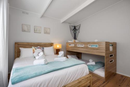 a bedroom with a bed with a bunk bed at Dundas Escape in Rye