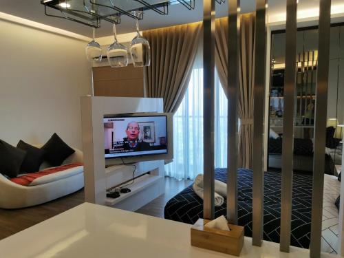 a living room with a tv and a couch at Apple Home 1 @ Menara Simfoni/Symphony Tower C180/Cheras/Mines/Balakong/Kuala Lumpur in Seri Kembangan