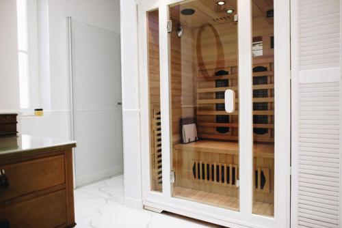 a glass cabinet in a kitchen with a wine cellar at 1st Floor Apartment in Toruń