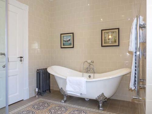 a bathroom with a white tub in a room at Farmhouse in Lisdoonvarna