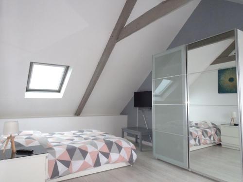 - une chambre mansardée avec un lit et une armoire en verre dans l'établissement Stone House in Plouezec near Goelo Coast, à Plouézec