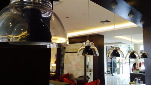 a restaurant with three pendant lights hanging from the ceiling at Carnaval Hotel Casino in Encarnación
