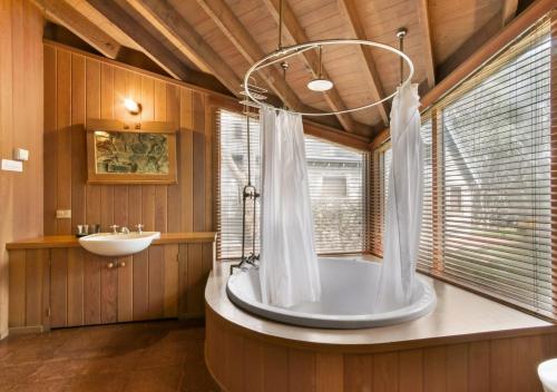 a large bathroom with a tub and a sink at Seadog in Dinner Plain