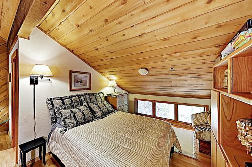 a bedroom with a bed in a room with wooden ceilings at Ridgepoint Haven 103 in Park City
