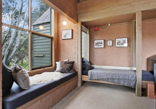 a bedroom with two beds and a window at Snowgums 10 in Dinner Plain
