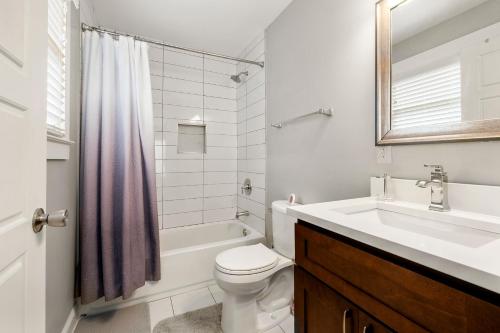 a white bathroom with a sink and a toilet at Lovely Cozy Studio in Heart of Atlanta in Atlanta