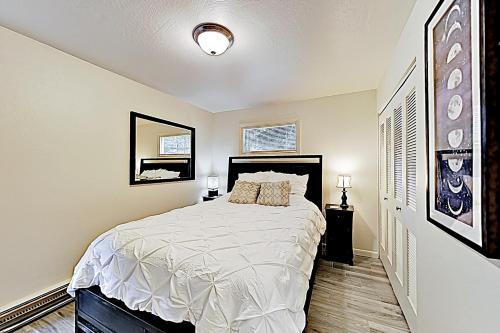 a bedroom with a large bed with white sheets at Homestake Haven 366 in Park City