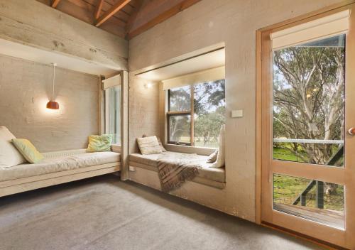 a room with two windows and a window seat at Snowgums 18 in Dinner Plain