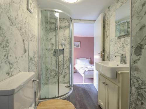a bathroom with a shower and a sink at Squires Rest in Welshpool