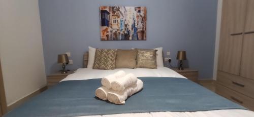 a bedroom with a bed with two towels on it at Searenity in Marsaxlokk