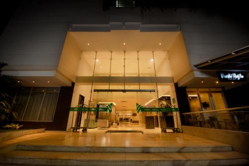 a lobby of a building with green flags in it at Wyndham Garden Barranquilla in Barranquilla