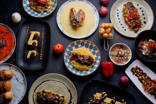 a table topped with plates of food and bowls of food at Wyndham Garden Barranquilla in Barranquilla