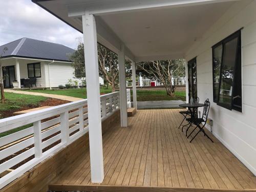 a porch with a table and chairs on a house at Aroma House in Pokeno