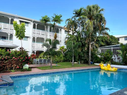a swimming pool in front of a hotel with a yellow float at City Terraces Cairns in Cairns