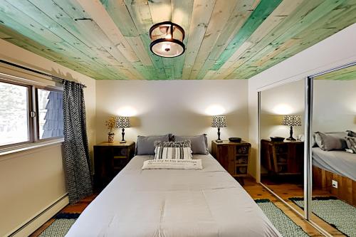 a bedroom with a bed and a coffered ceiling at Mountain Escape in Taos Ski Valley