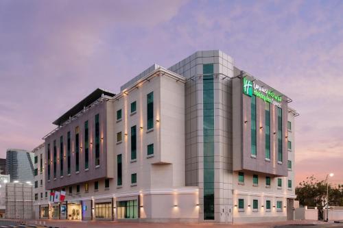 a building with a sign on the side of it at Holiday Inn Express Dubai Safa Park by IHG in Dubai
