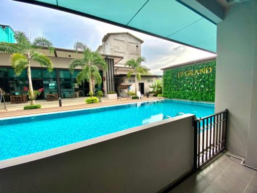 a swimming pool in front of a building at J.P.GRAND HOTEL in Trat
