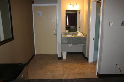 a bathroom with a sink and a mirror at Bangor Inn & Suites in Bangor
