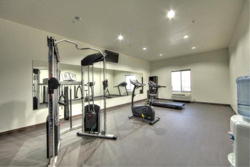 a gym with several treadmills and machines in a room at Comfort Inn & Suites, White Settlement-Fort Worth West, TX in Fort Worth