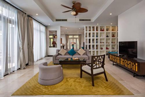 a living room with a couch and a table at Da Nang Paradise Center My Khe Beach Resort & Spa in Da Nang