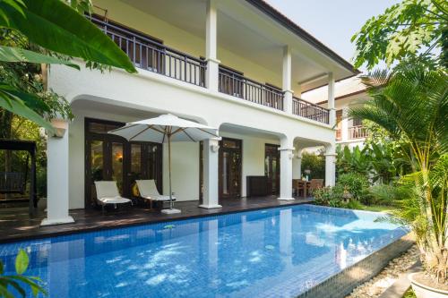 a swimming pool in front of a villa at Da Nang Paradise Center My Khe Beach Resort & Spa in Da Nang