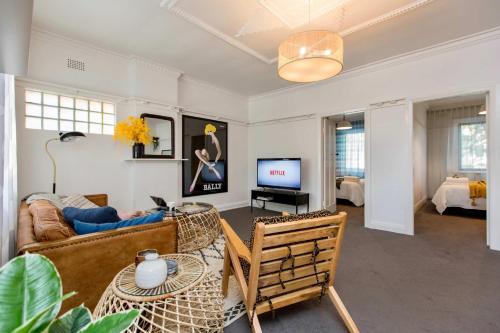 a living room with a couch and a table at The Baylis Boutique Apartments in Wagga Wagga