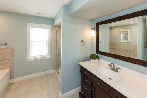 a bathroom with a sink and a mirror at Count Your Blessings in Virginia Beach