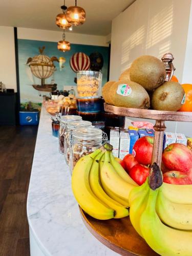 a buffet with bananas and other fruits on a counter at Hotel Bell-X Kortrijk-Wevelgem in Wevelgem