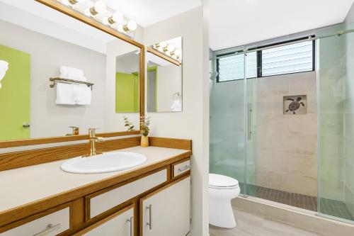 a bathroom with a sink and a shower at Casa Tropical Kona in Kailua-Kona