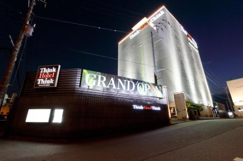 a large building with a grand canyon sign at night at Think・Hotel・Think in Ebina