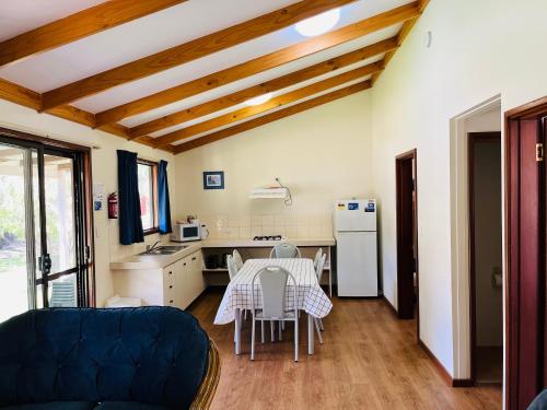 a living room with a table and a kitchen at BIG4 Taunton Farm in Cowaramup