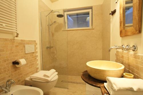 a bathroom with a tub and a sink and a shower at Le Petit Palais Villa in Plesio
