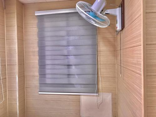 a shower with a glass window in a bathroom at Maine City Residences Leveriza in Manila